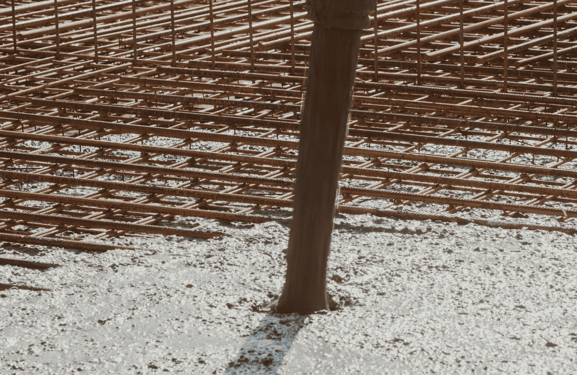 Stone Haven Developments Wet concrete being poured over a reinforced steel rebar grid at a construction site. Ontario