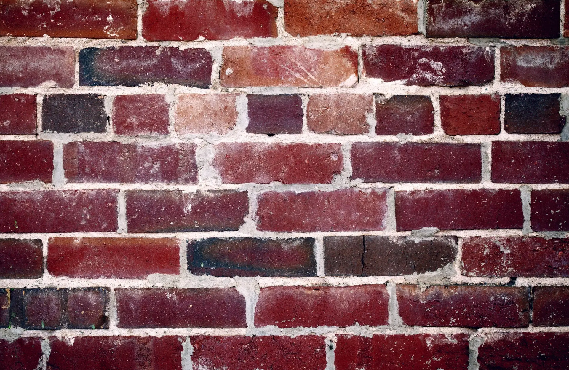 Stone Haven Developments A close-up view of a red brick wall with visible mortar lines and varying brick shades. Ontario