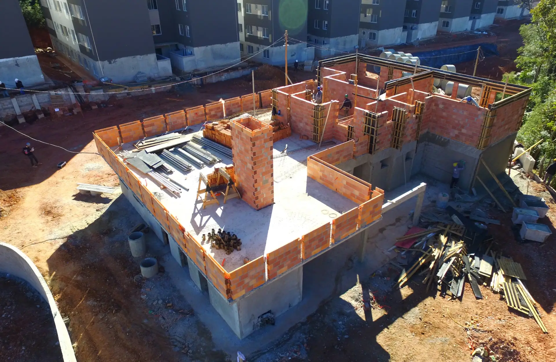 Stone Haven Developments Aerial view of a multi-story building under construction with exposed brick walls, scaffolding, and construction materials on site. Ontario