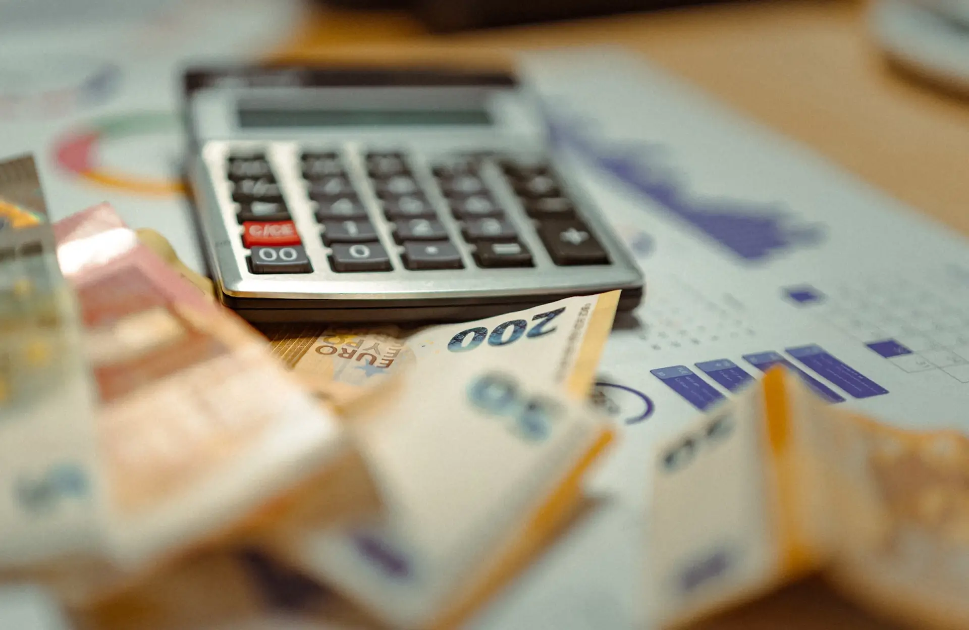 Stone Haven Developments A calculator and several euro banknotes are placed on top of printed financial charts with bar graphs. Ontario