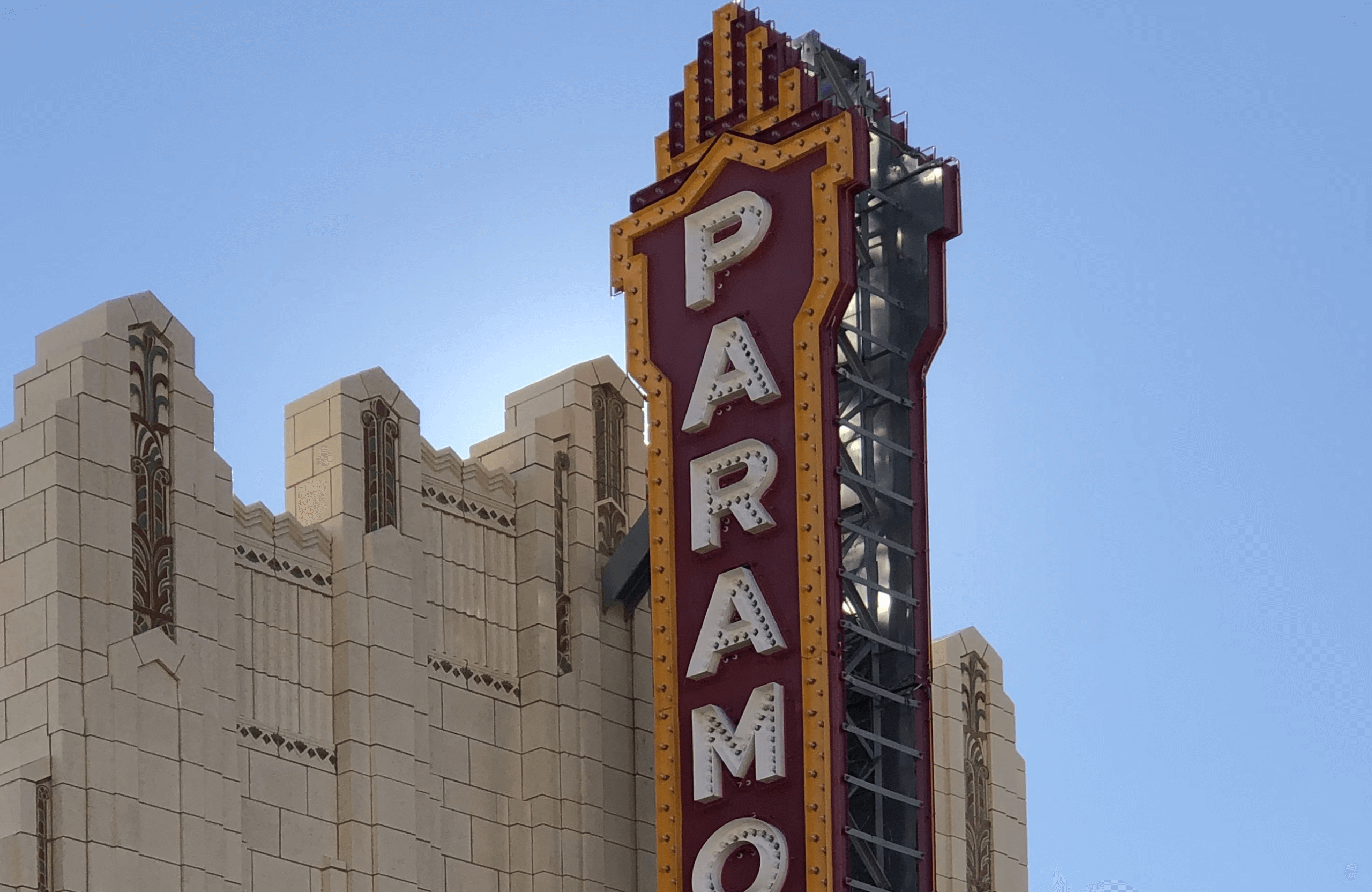 Stone Haven Developments The image shows the vertical marquee sign of the Paramount Theatre against a clear blue sky, attached to an art deco style building. Ontario